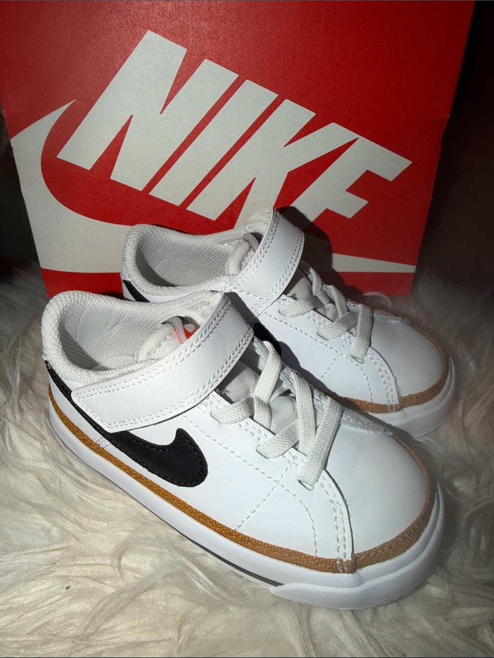 Nike Kids White Sneakers with Black Swoosh and Gold Trim